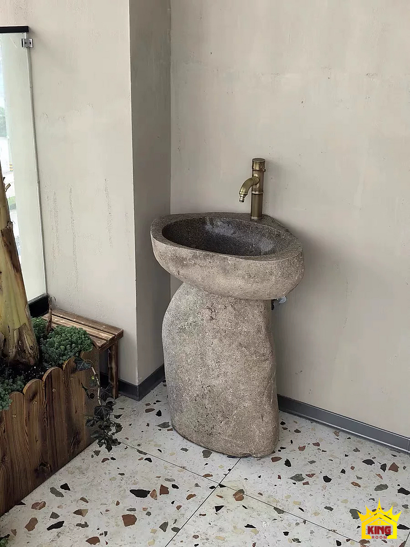 Lavabo đá cuội chân trụ – Bộ đá sáng đặt tại góc tường cho thấy khoảng sàn quanh chân Bộ đá sáng đặt tại góc tường cho thấy khoảng sàn quanh chân
