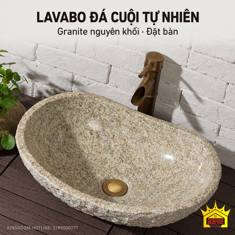Chậu lavabo đá cuội tự nhiên granite xám be đặt trên bàn gỗ, phối vòi dáng ống tre tông đồng
